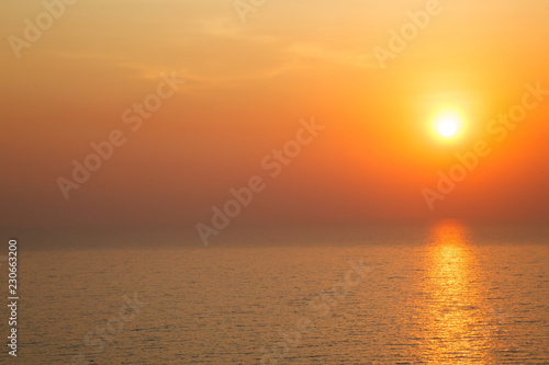 horizontal view of Sunset golden light reflecting on sea wave ripple surface background. Abstract, tranquility, serenity, romance, refresh, relaxation, rest, beauty in nature concept. © Victorflowerfly