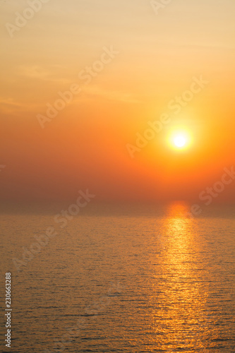 Vertical view of Sunset golden light reflecting on sea wave ripple surface background. Abstract  tranquility  serenity  romance  refresh  relaxation  rest  beauty in nature concept.