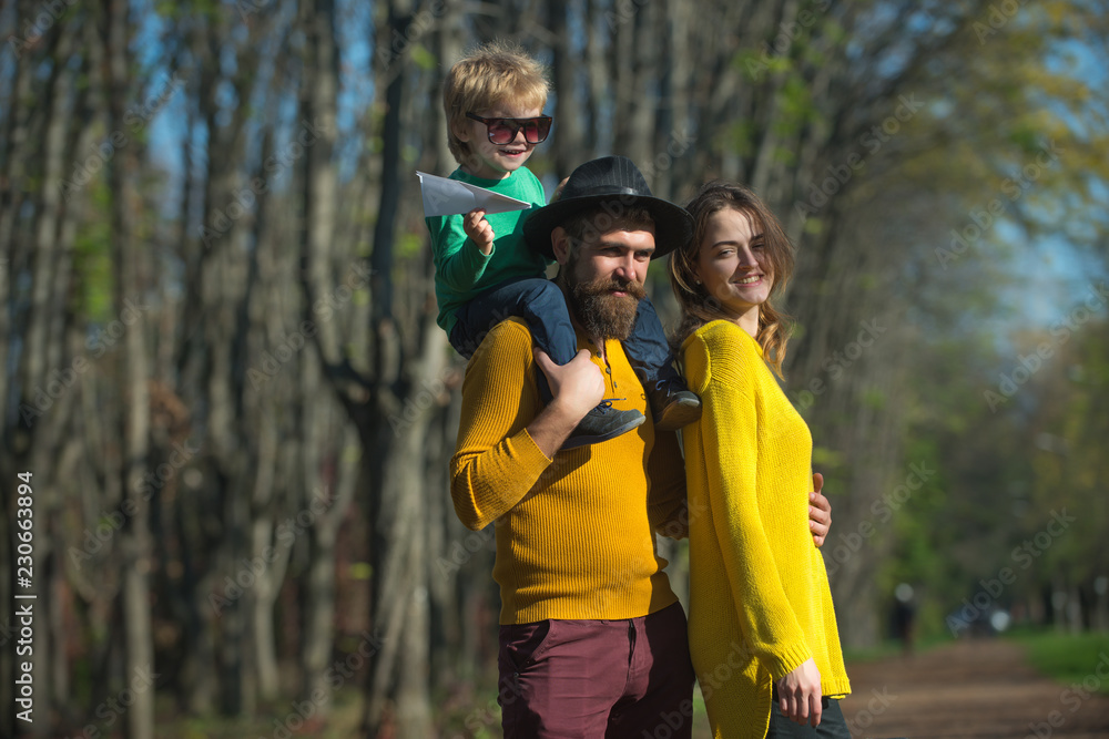 Happy family and little child with paper plane enjoy freedom outdoor. Freedom of movement. Happiness is free Happy family and little child with paper plane enjoy freedom outdoor. Freedom of movement. Happiness is free