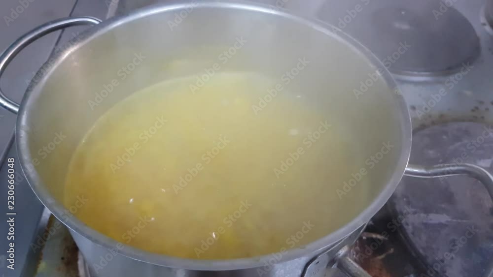 saucepan with soup on an electric stove. preparing a business lunch in the restaurant. lunch for a big family saucepan with soup on an electric stove. preparing a business lunch in the restaurant. lunch for a big family