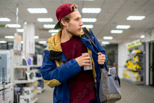shoplifter in the electronic store supermarket stealing new gadget f photo