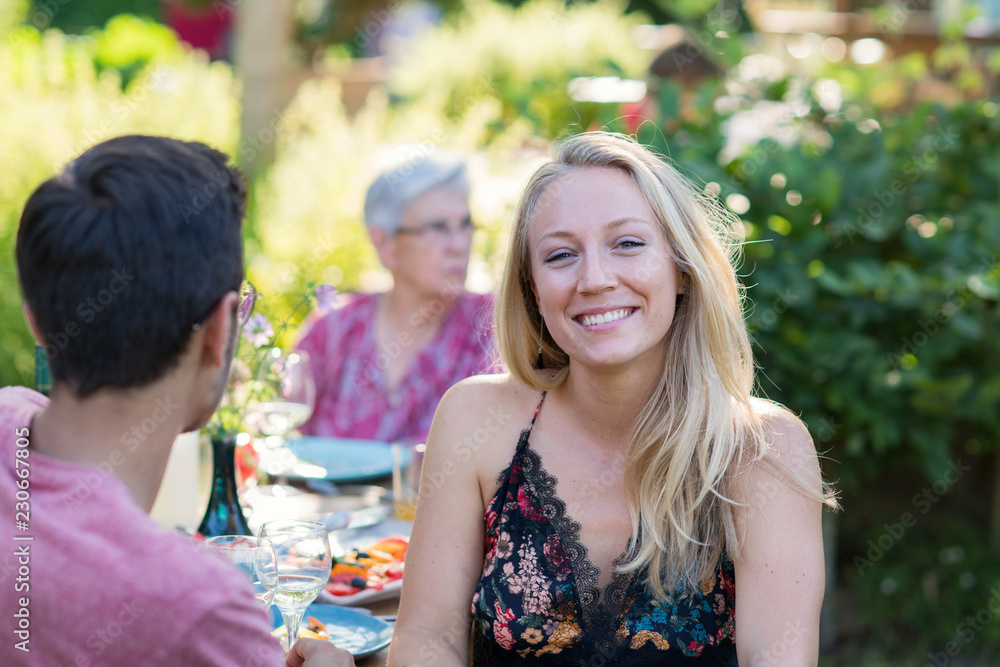 Obraz premium Family picnic. Focus to a beautiful young woman looks at camera