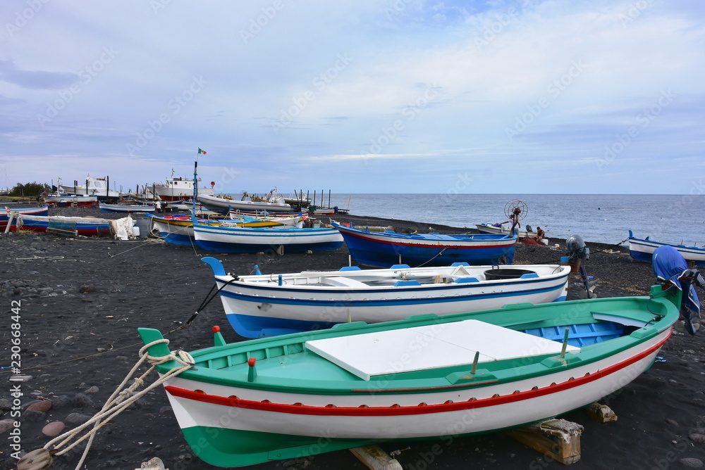 Stromboli island ,black sand and small boats
