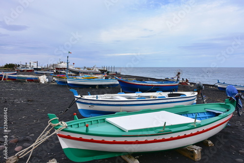 Stromboli island ,black sand and small boats 