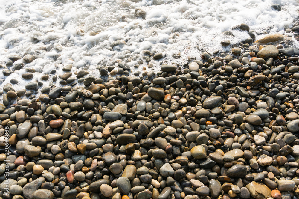 Waves washing small stones close up Waves washing small stones close up