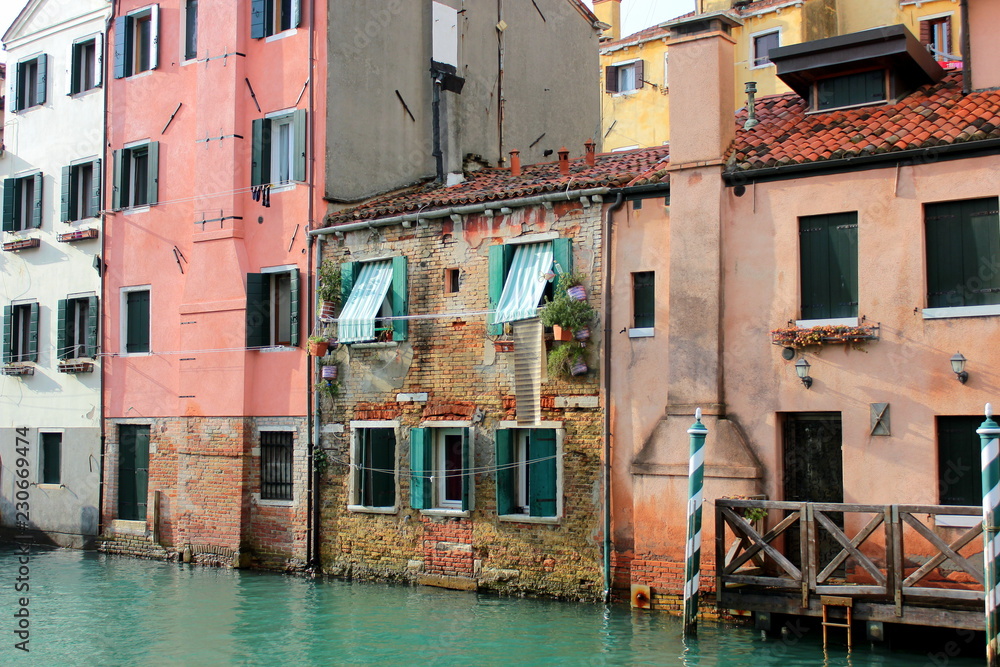 The canal in Venice. Ancient houses,  reflection in the water.