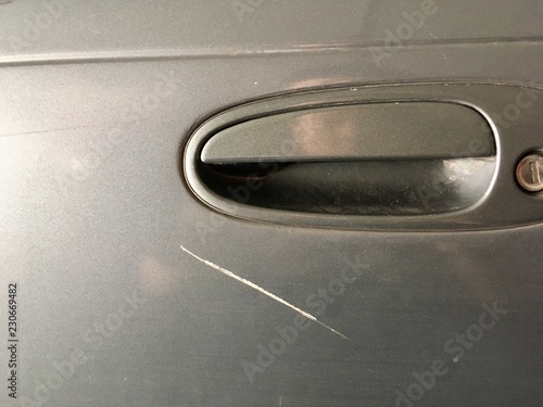 Grazed Scratch on Car - The gray car is scratched by the crashes caused by the careless driving.