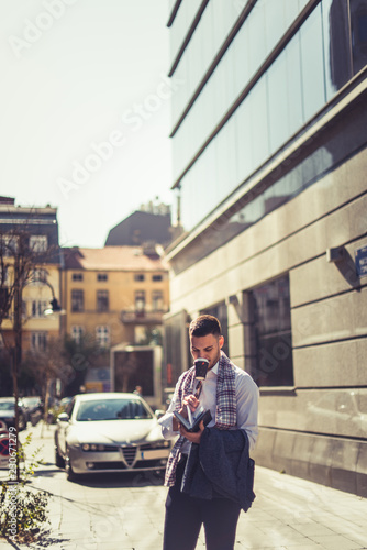 Handsome businessman drinking coffee in the city © qunica.com
