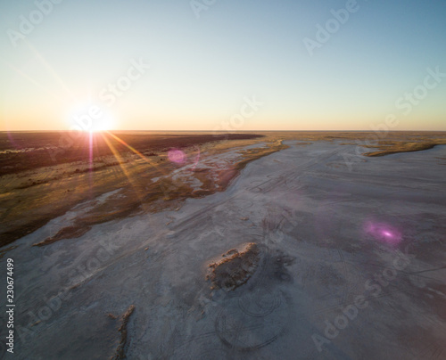 Aerial view of sunset over Tshitane Salt Pan in the salt flats area of Kalahari, Botswana, Africa. photo