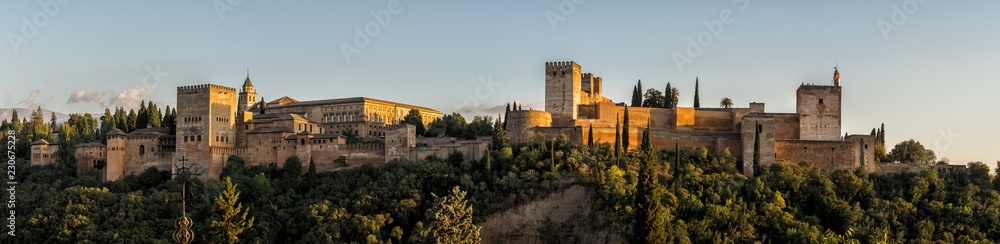 Panorama photograph of the Alhambra Palace of Granada Spain at sunset.  Vast medieval fortress castle complex overlooking Granada, built by the Moorish Empire.  