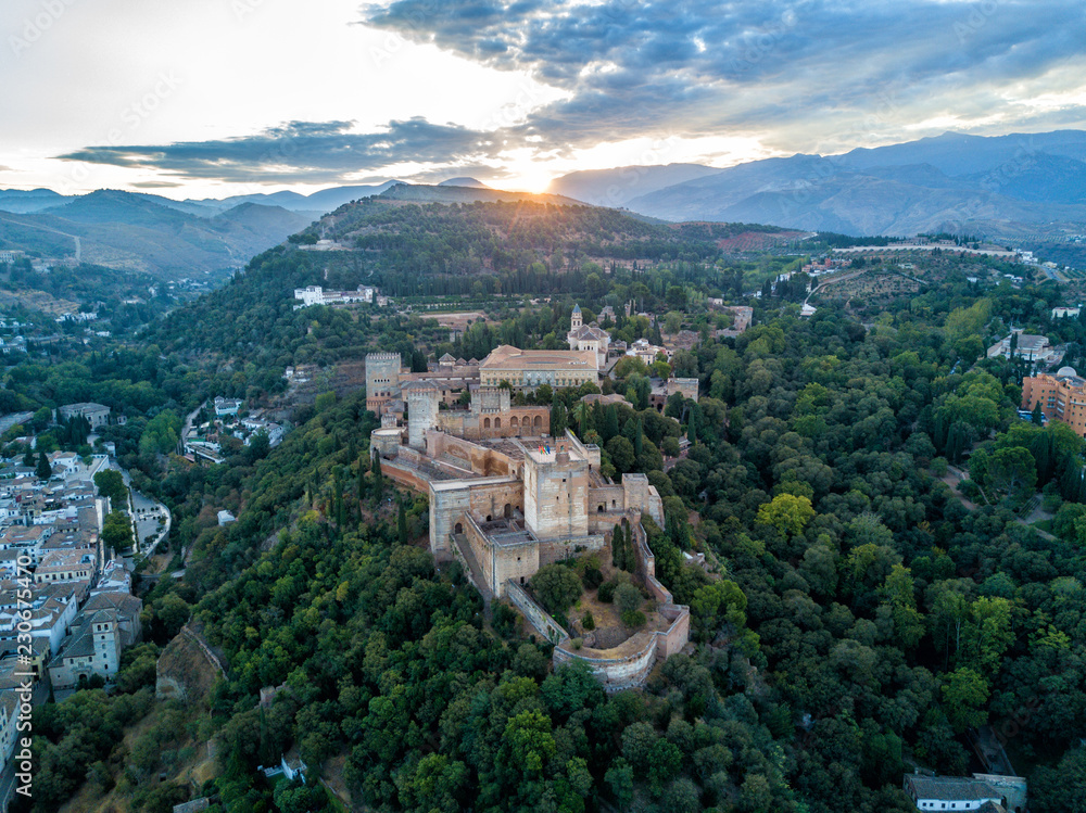 Aerial drone photo of The Alhambra Palace of Granada Spain at sunrise.  Vast castle fortress complex overlooking Granada, built by the Moorish Empire.  