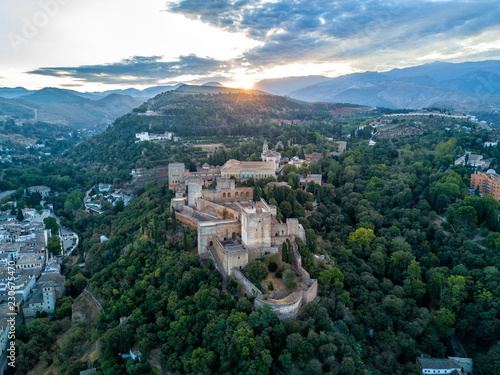 Aerial drone photo of The Alhambra Palace of Granada Spain at sunrise. Vast castle fortress complex overlooking Granada, built by the Moorish Empire. 