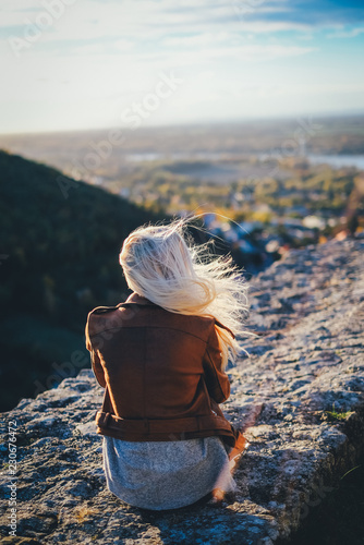 Photography woman sitting on a rock