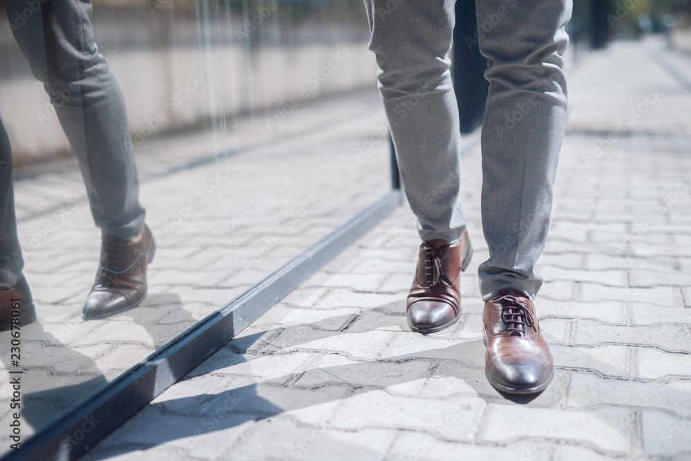 Close up businessman`s walking legs. Street exterior. Close up businessman`s walking legs. Street exterior.