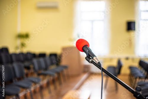 Photography Red microphone in an empty room, the concept of emptiness and despair in human life, emptiness and the abyss in the soul of a lonely creature