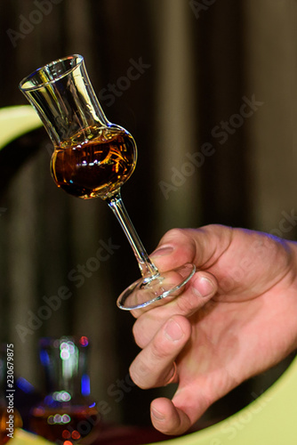 Man sampling whiskey from a whiskey tasting glass