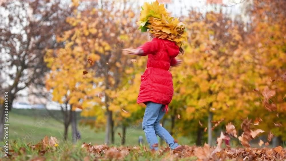 Young girl playing with leaves at autumn park Young girl playing with leaves at autumn park