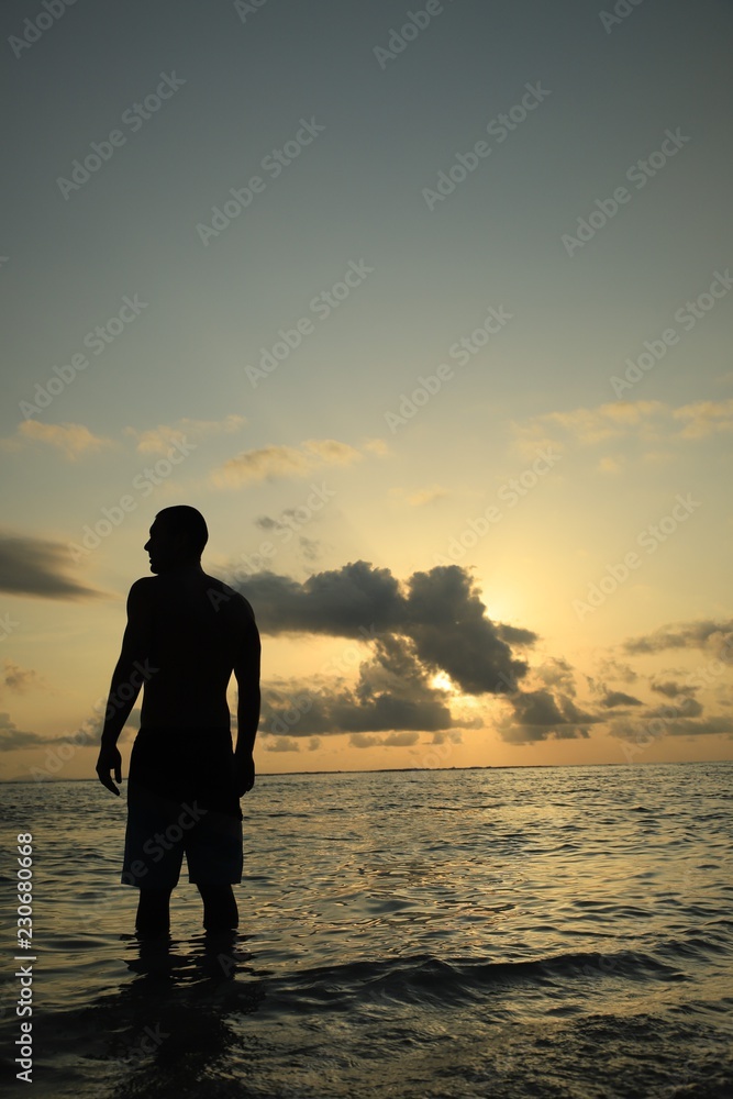Silhouette of a man in the ocean