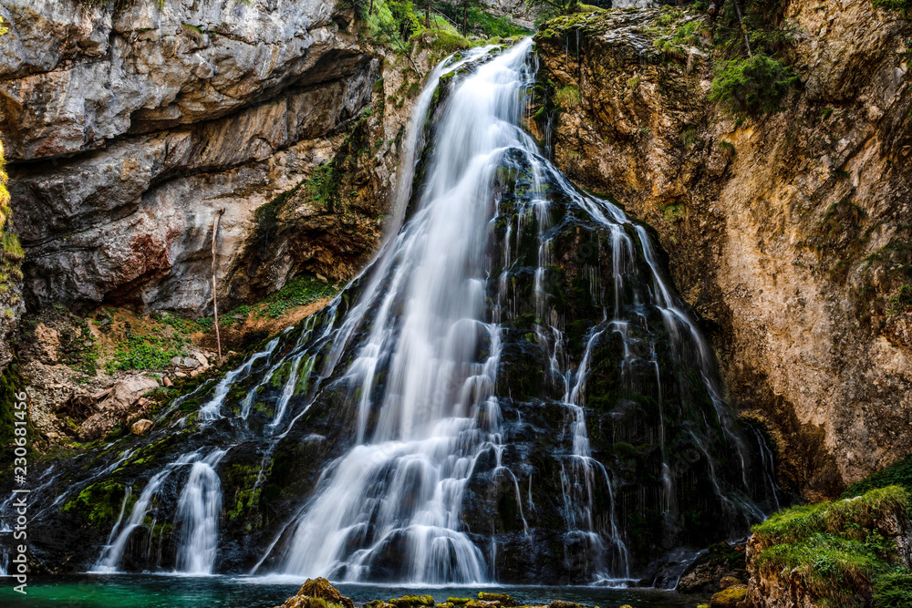 Beautiful view of famous Gollinger Wasserfall with mossy rocks and green trees, Golling, Salzburger Land, Austria Beautiful view of famous Gollinger Wasserfall with mossy rocks and green trees, Golling, Salzburger Land, Austria