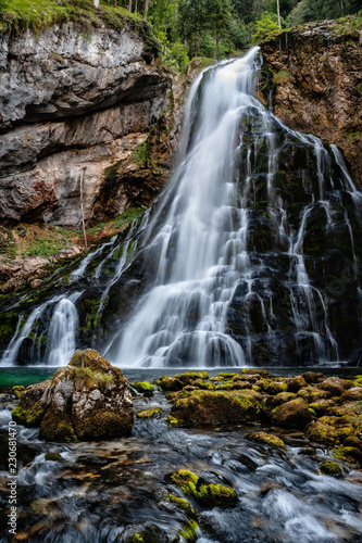 Fototapeta Naklejka Na Ścianę i Meble -  Beautiful view of famous Gollinger Wasserfall with mossy rocks and green trees, Golling, Salzburger Land, Austria