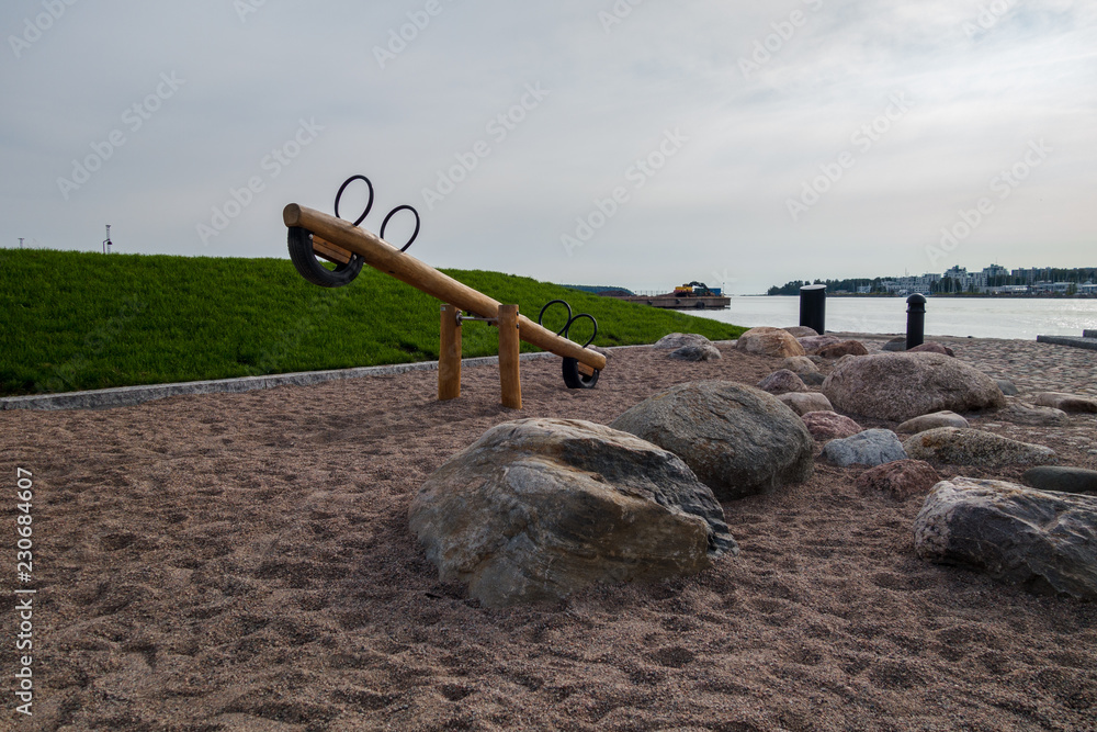 Kids playground at the coast with a bench swing, Helsinki Finland