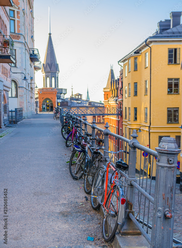 Row of parked Bikes, bicycles near railing, Stockholm, Sweden