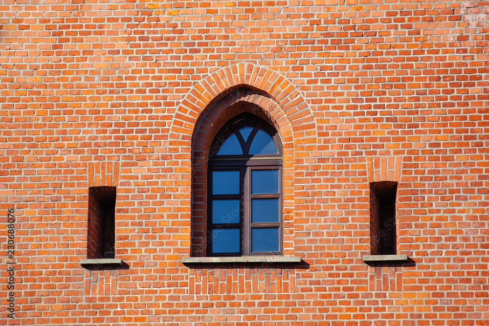 old weathered brick wall with windows in gothic style old weathered brick wall with windows in gothic style