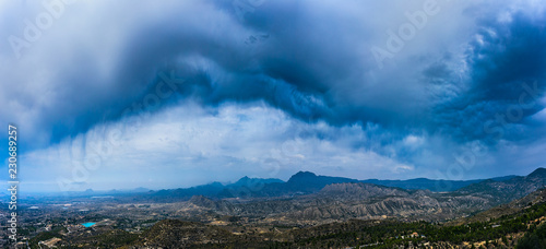 Wide panorama of storm clouds over Spain mountains