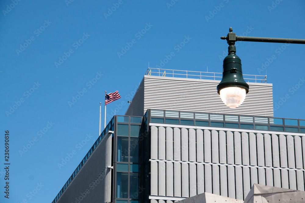 Building with a american flag on the roof in downtown Manhattan in New York City, USA
