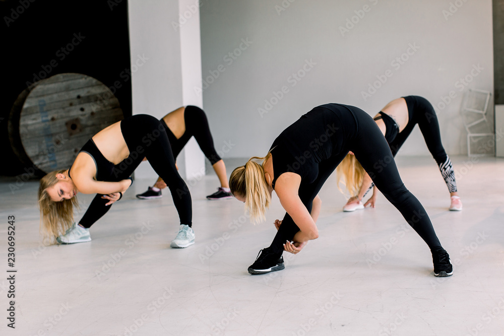 People at the health club with personal trainer, learning the correct form. People at the health club with personal trainer, learning the correct form.