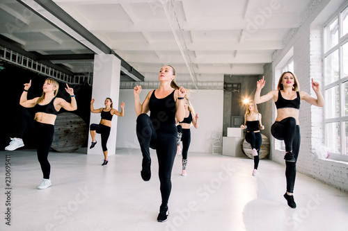 Happy positive smiling men women performing modern dance in fitness studio © sofiko14