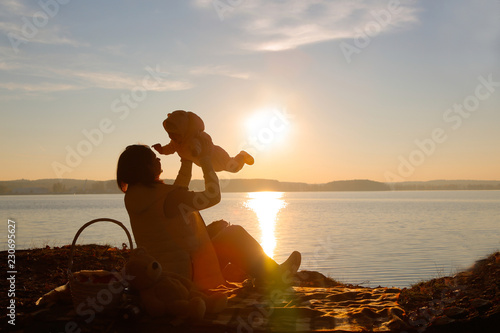 Mom and daughter in the evening playing on the beach