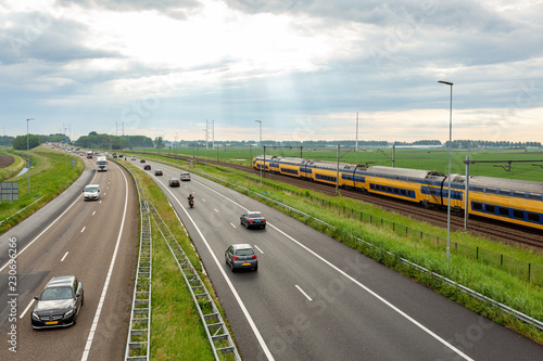 Cars on the A44 highway and a train near Abbenes.