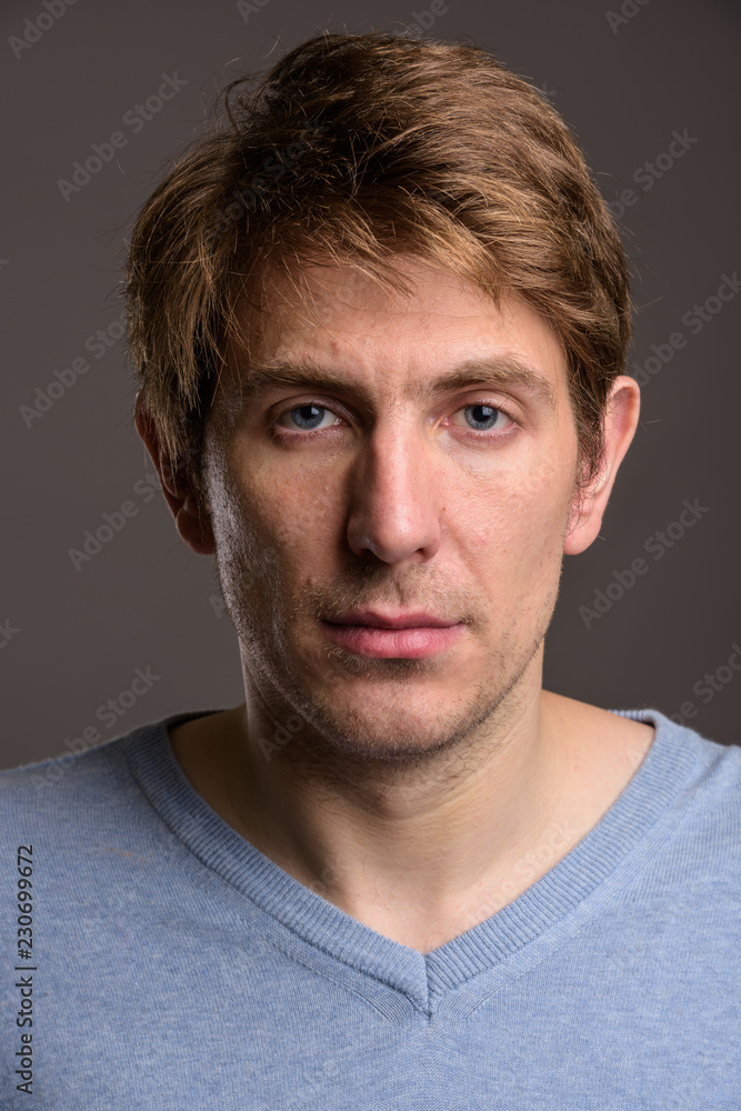 Portrait of handsome man against gray background Portrait of handsome man against gray background