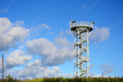 Spiral staircase of lookout tower, construction with metal steps. Observation tower, post or point, place from which to keep watch or view landscape. photo