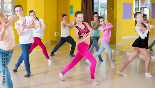 Children participating in dance class with teacher