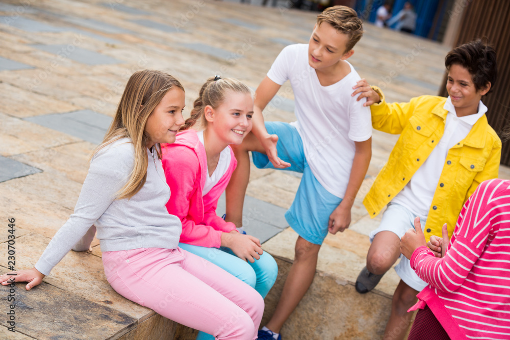 Fototapeta premium Two boys and three girls are talking about play on walk