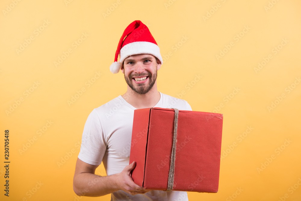 online christmas shopping. Happy new year. happy santa man on yellow background. man in santa hat hold christmas present. The morning before Xmas. delivery christmas gifts. Christmas composition online christmas shopping. Happy new year. happy santa man on yellow background. man in santa hat hold christmas present. The morning before Xmas. delivery christmas gifts. Christmas composition