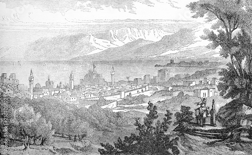 Vintage engraving of Beirut one of the oldest cities in the world, with defence walls, towers, on the sea border with the view of Mount Sannine photo