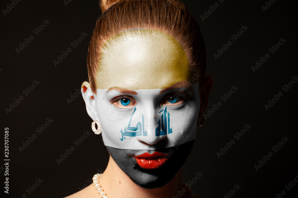 Portrait of woman face with painted flag of Iraq against black background Portrait of woman face with painted flag of Iraq against black background