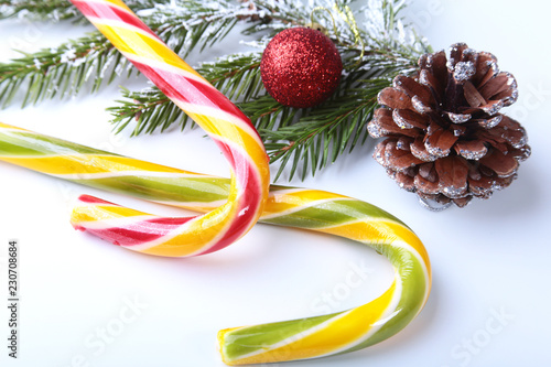 Christmas tree, gift box, lollipop and colored balls on white background. copy space.
