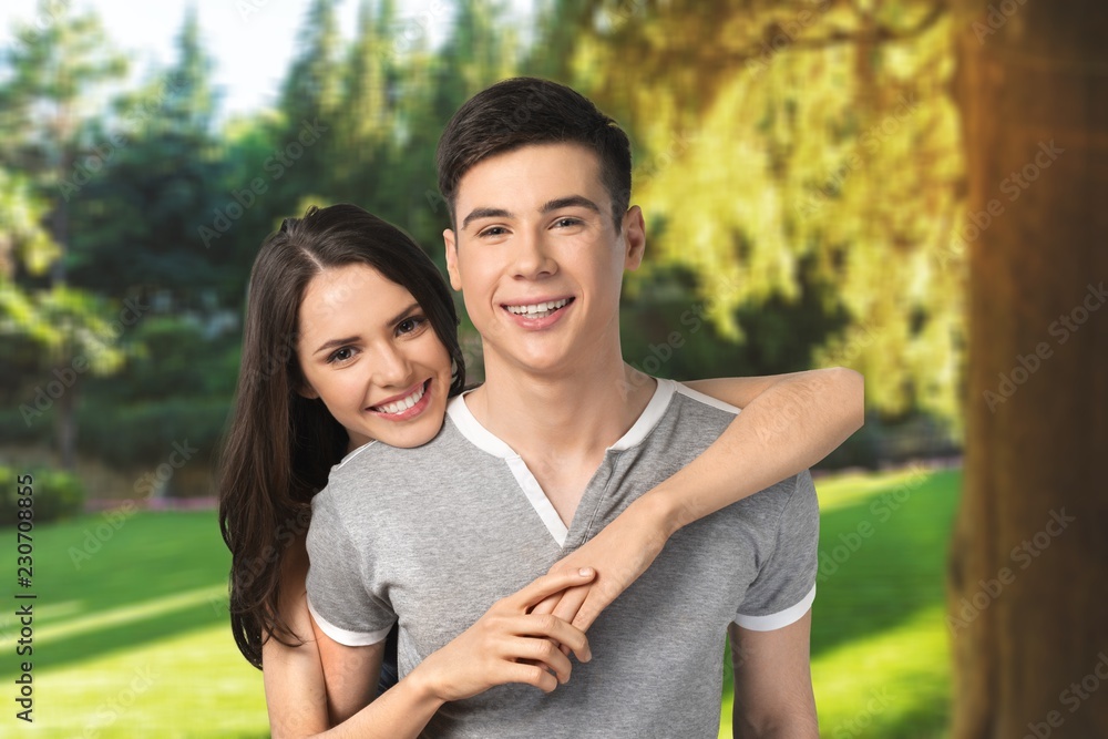 Happy young beautiful couple on blue background