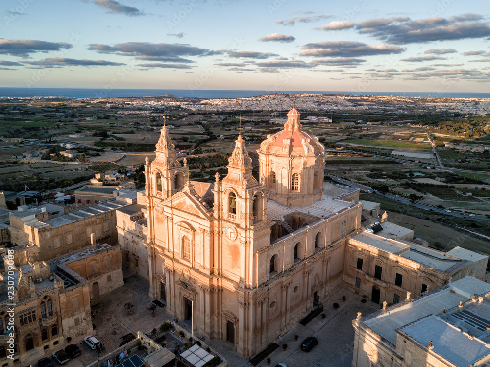 Aerial drone photo - St. Paul's Cathedral at sunset in the ancient medieval city of Mdina, Malta.