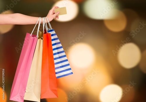 Woman with shopping bags and card on