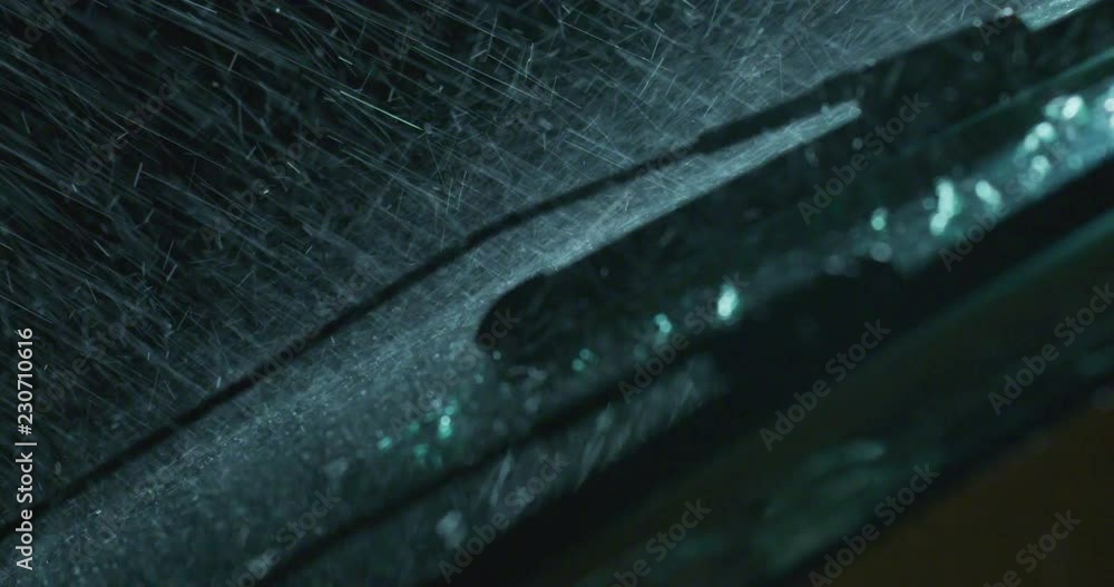 Super close up of a carglass while it’s raining, the wipers are taking off the water from it. Concept: thunderstorm, car, weather. Shot on Red Camera 8K Super close up of a carglass while it’s raining, the wipers are taking off the water from it. Concept: thunderstorm, car, weather. Shot on Red Camera 8K