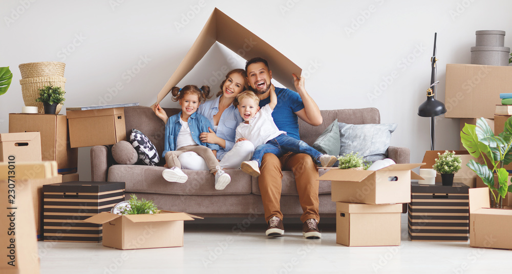 happy family mother father and children move to new apartment and unpack boxes. happy family mother father and children move to new apartment and unpack boxes.