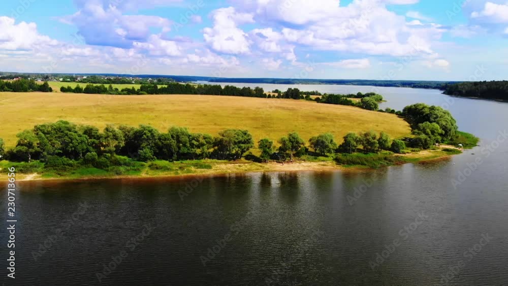 Ruza, Russia - August, 2018: Wonderful lake on a peninsula against the blue sky with beautiful clouds. Ruza, Russia - August, 2018: Wonderful lake on a peninsula against the blue sky with beautiful clouds.