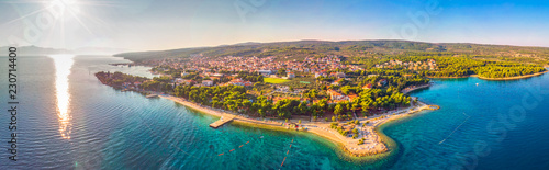 Aerial view of seaside promenade in Supetar town on Brac island with palm trees and turquoise clear ocean water, Supetar, Brac, Croatia, Europe