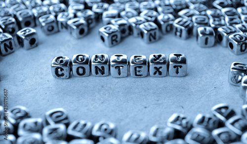 Context - Word from Metal Blocks on Paper - Concept Photo on Table
