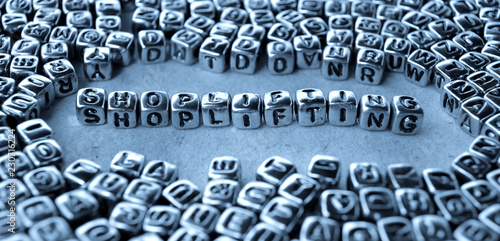 Shoplifting, Shop Lifting - Word from Metal Blocks on Paper - Concept Photo on Table
